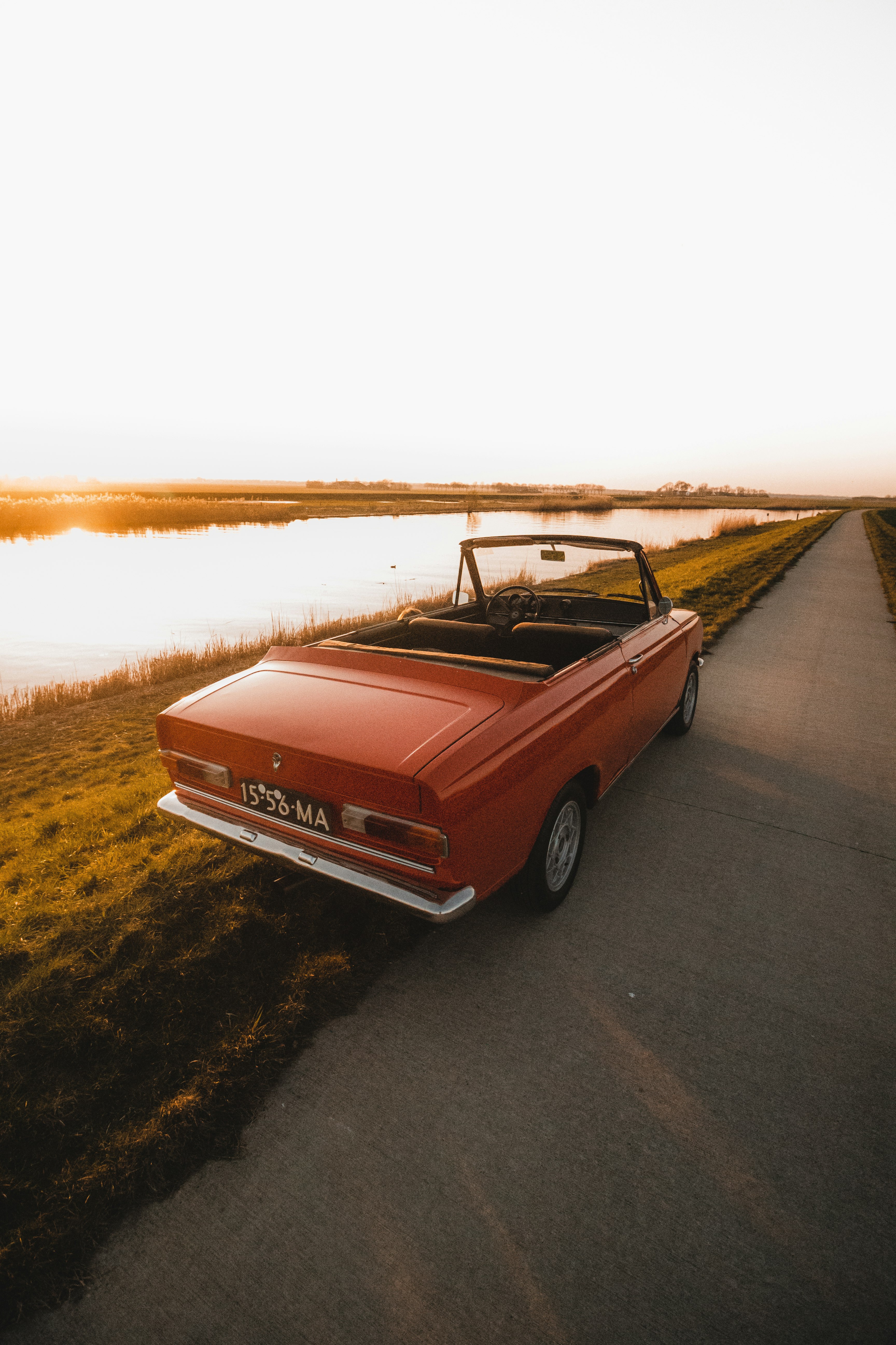 red chevrolet camaro on road during daytime